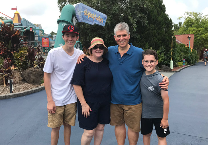 Terry's after photo with his family at an amusement park