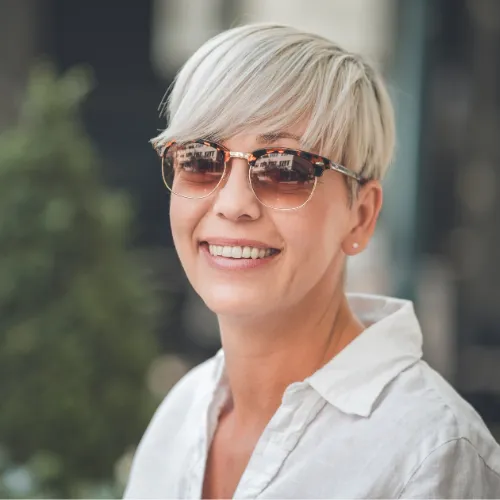 Young woman in sunglasses smiling