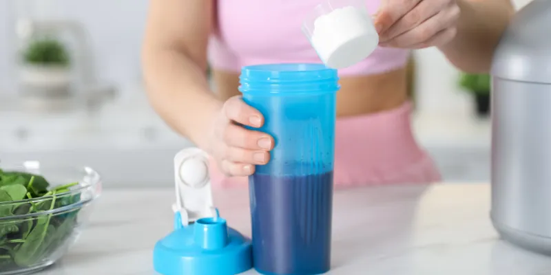 Woman preparing a protein shake