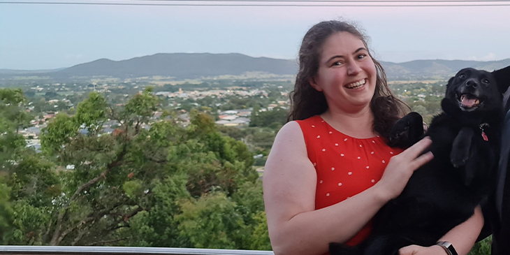 Danielle before photo with her dog, overlooking the mountains