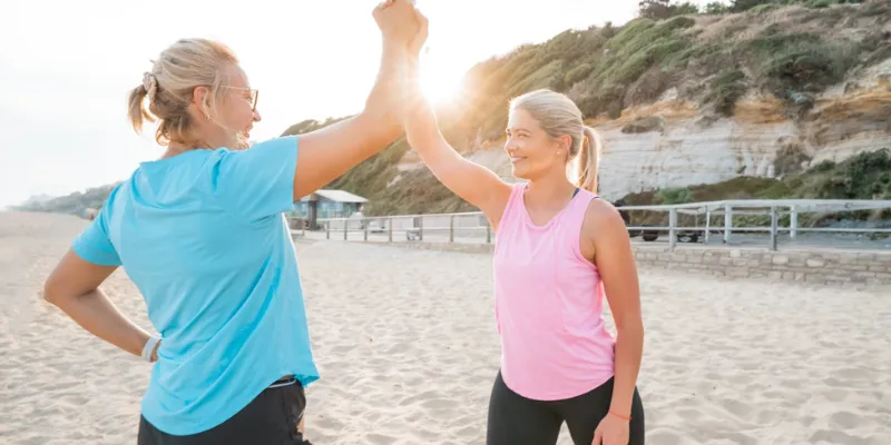 Two women smiling on the beach